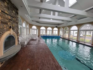 A pool deck with wood color and finish