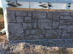 A concrete retaining wall with decorative pattern