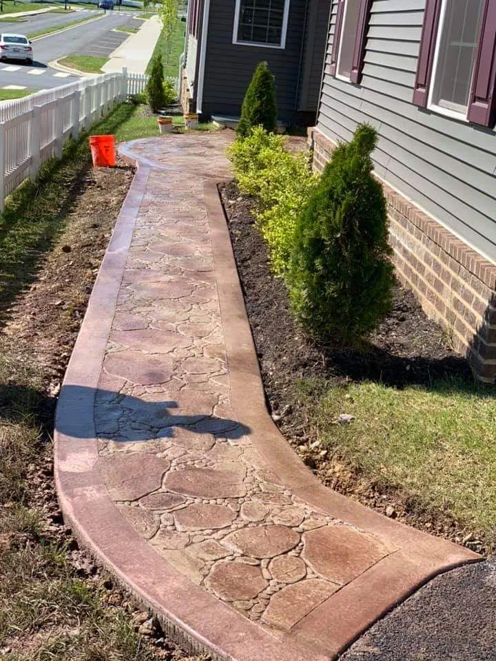 A curved concrete walkway with finish